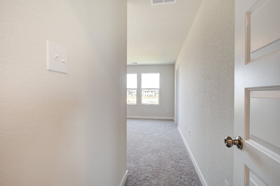 A hallway with white walls.