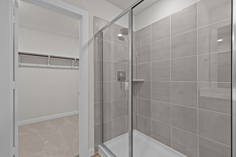 A shower with a glass door.