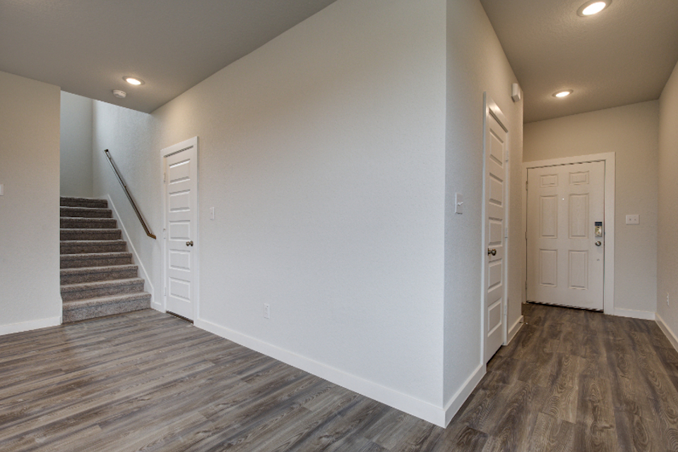 A hallway with white doors.