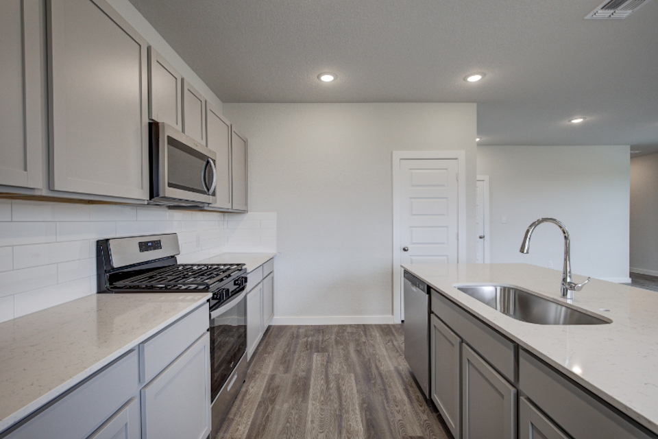 A kitchen with white cabinets.