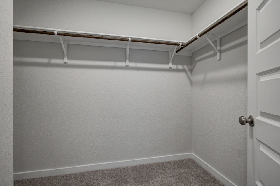 A white wall with a metal railing.