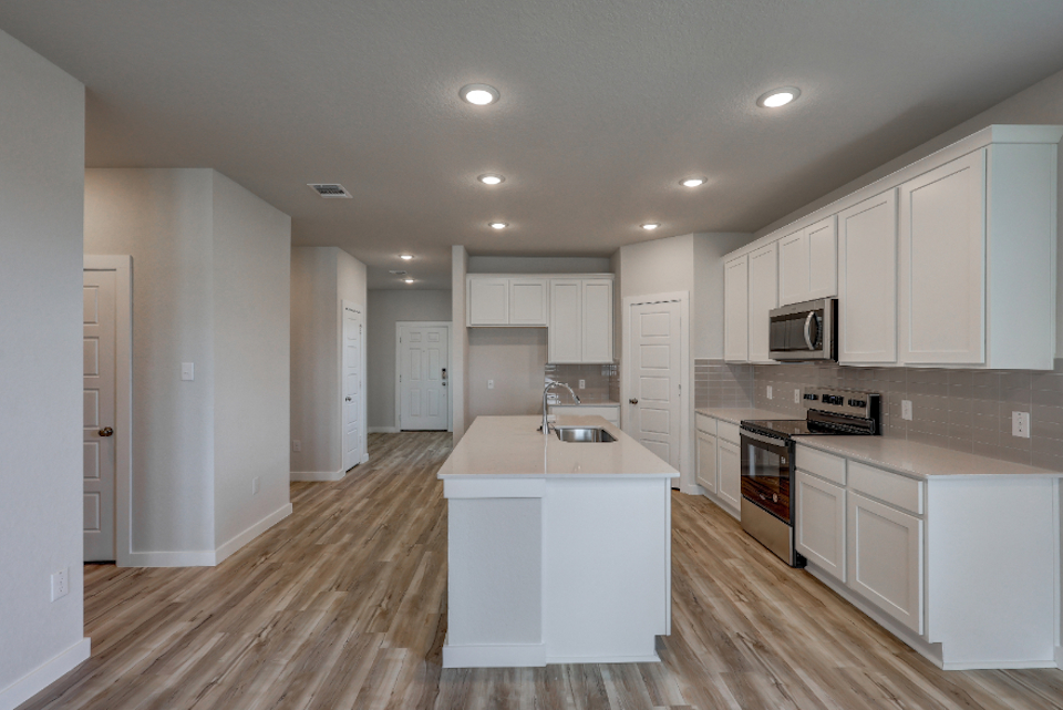 A kitchen with white cabinets.