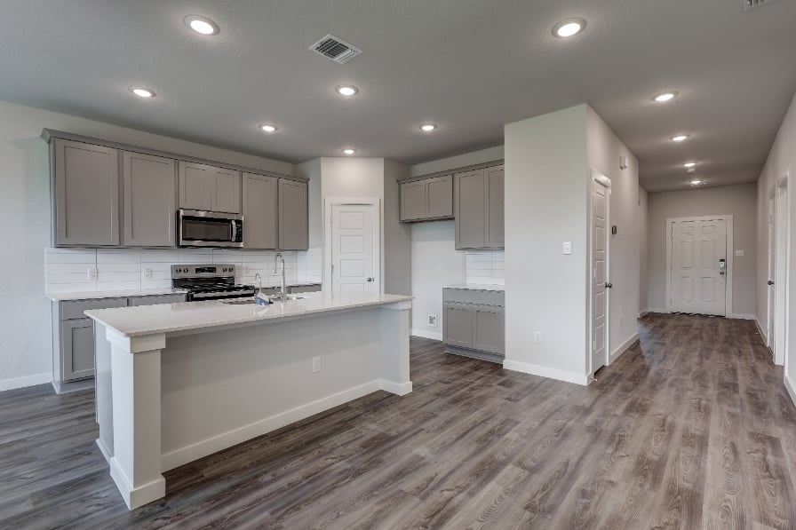 A kitchen with white cabinets.