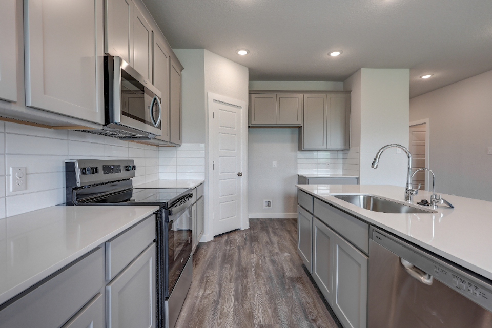 A kitchen with white cabinets.