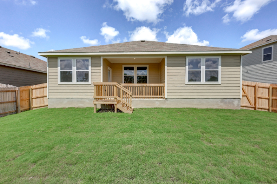 A house with a grass yard.