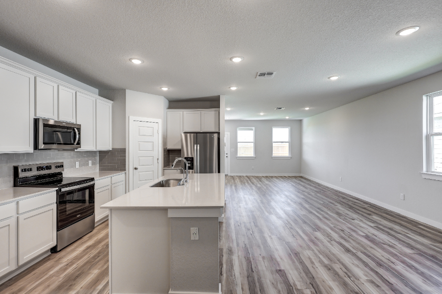 A kitchen with white cabinets.