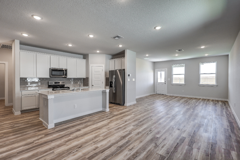 A large kitchen with white cabinets.