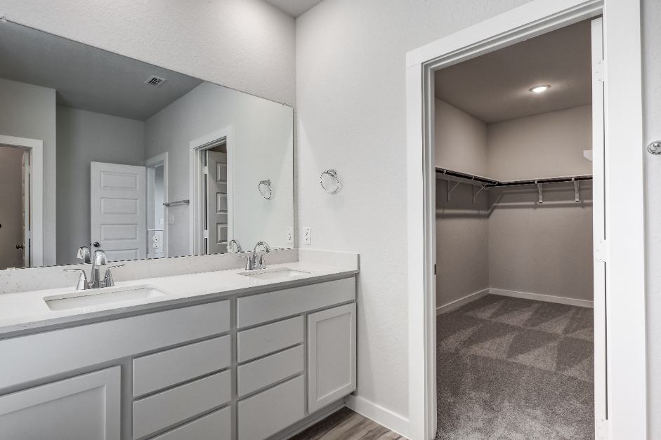 A bathroom with a large mirror.