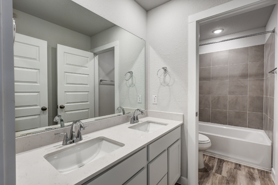 A bathroom with a tub sink and toilet.