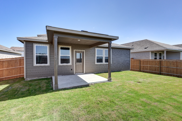 A house with a fence and grass.