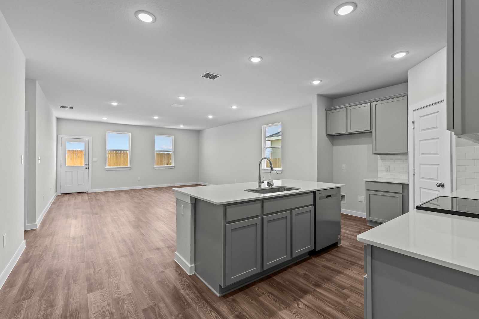 A kitchen with white cabinets.