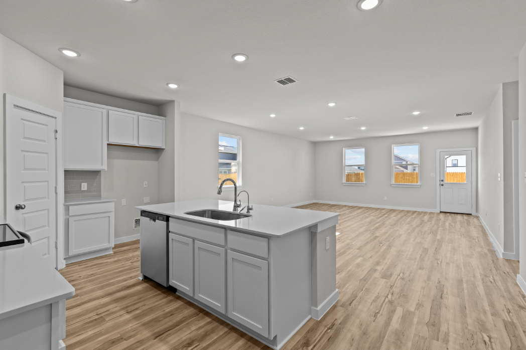 A kitchen with white cabinets.