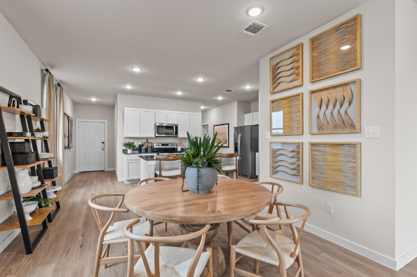 A kitchen with a dining table.