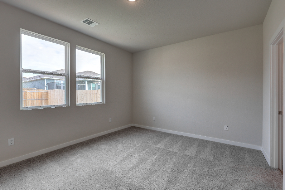 A room with a window and a carpet.