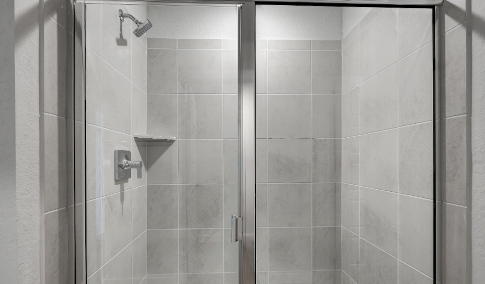 A shower with a glass door.