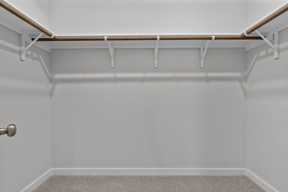 A white wall with a metal railing.