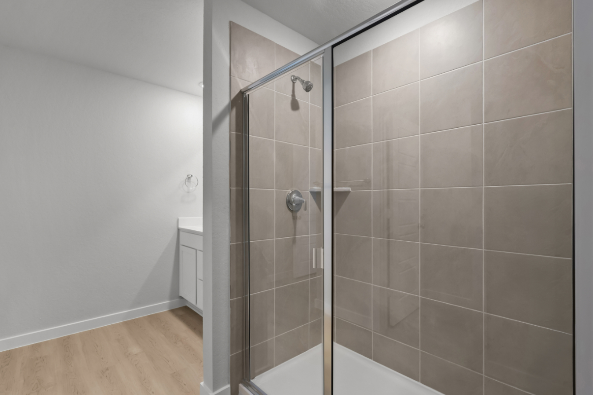 A shower with a glass door.