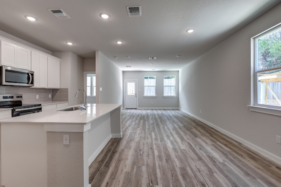 A kitchen with white cabinets.