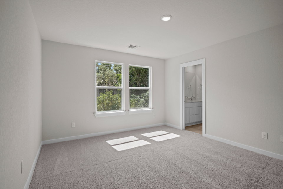 A room with a window and a rug.