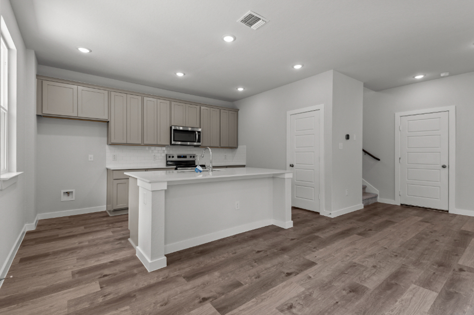 A kitchen with white cabinets.