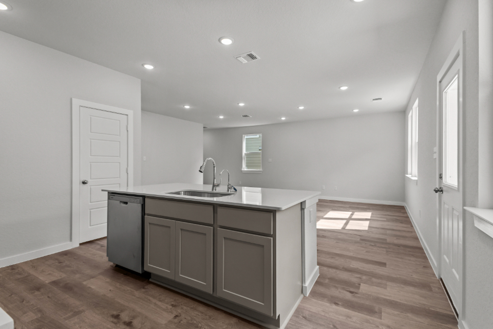 A kitchen with a wood floor.