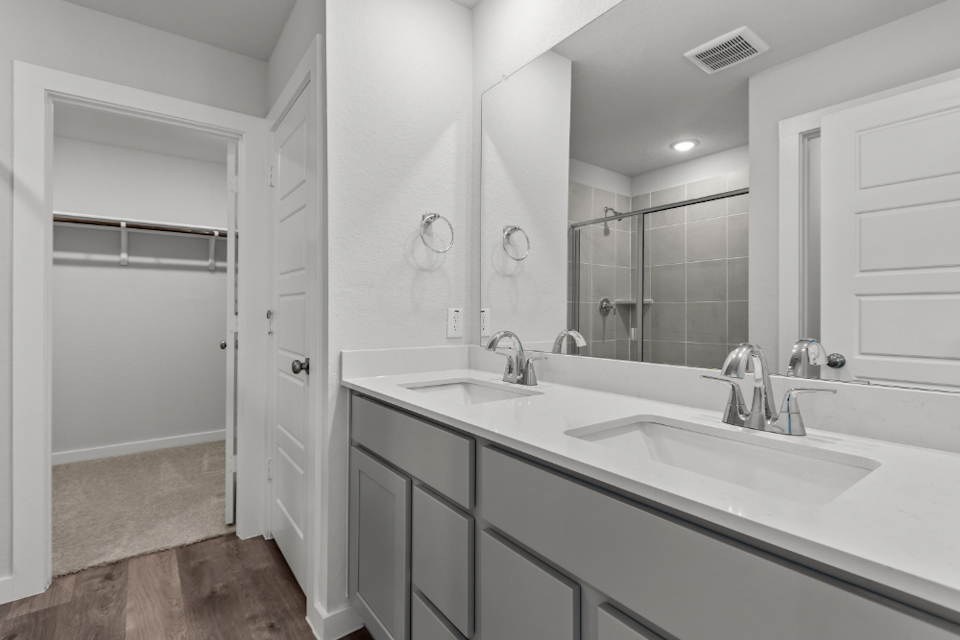 A bathroom with a large mirror.