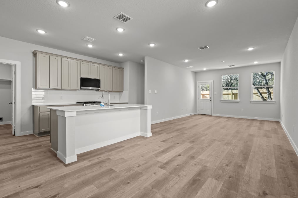 A kitchen with white cabinets.