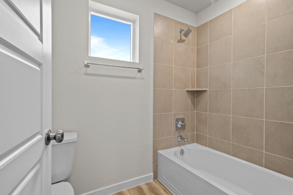 A bathroom with a tub toilet and sink.