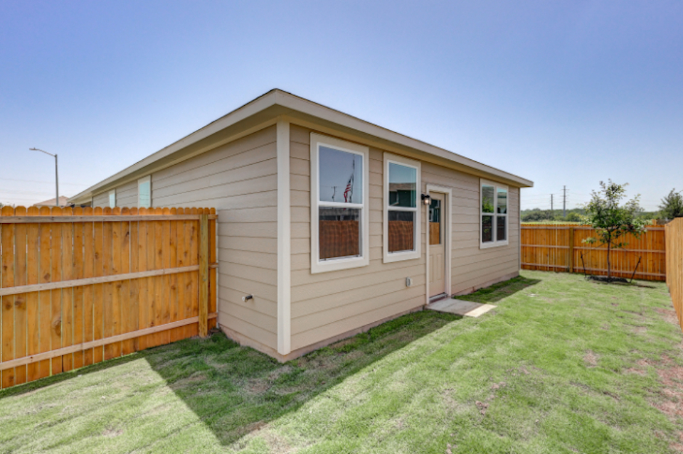 A small house with a fence.