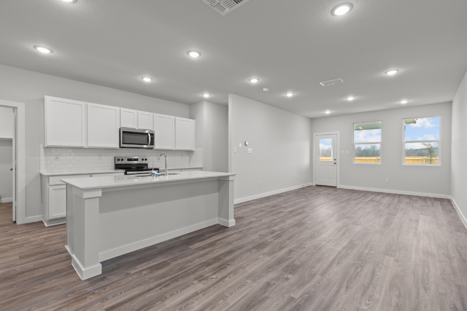 A kitchen with white cabinets.