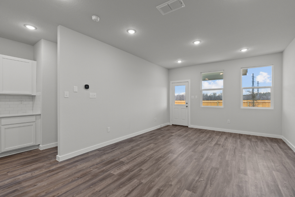 A room with white walls and a wood floor.