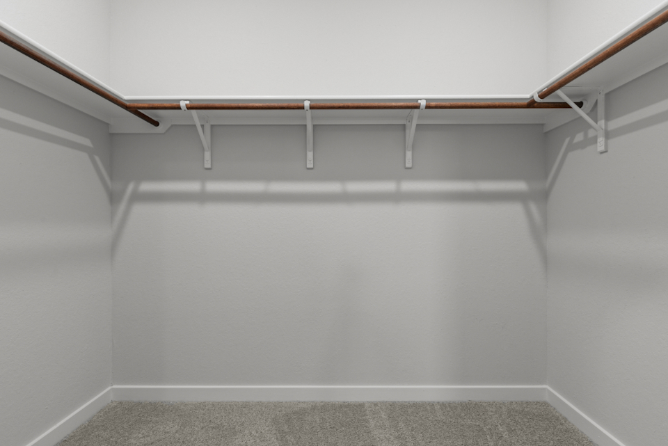 A white wall with a metal railing.