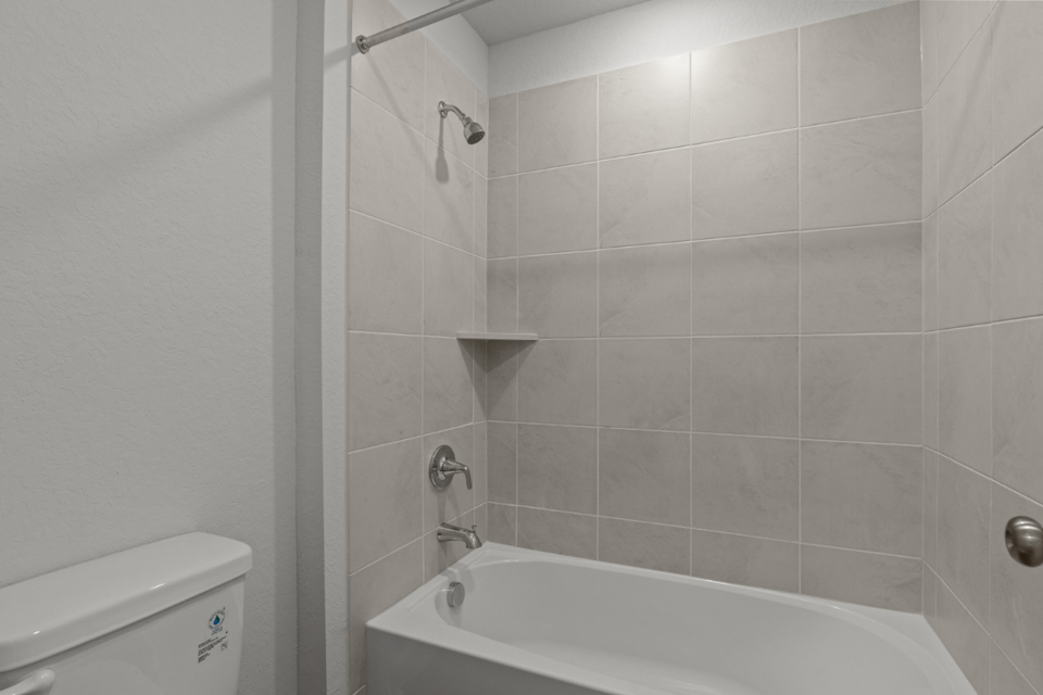 A bathtub in a bathroom.