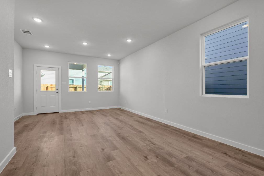 A room with a wood floor and white walls.
