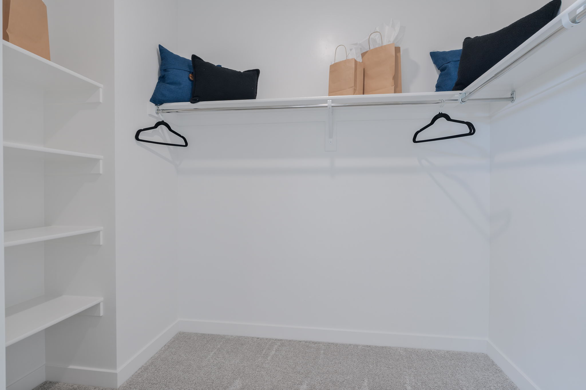 A white shelving unit with glasses.