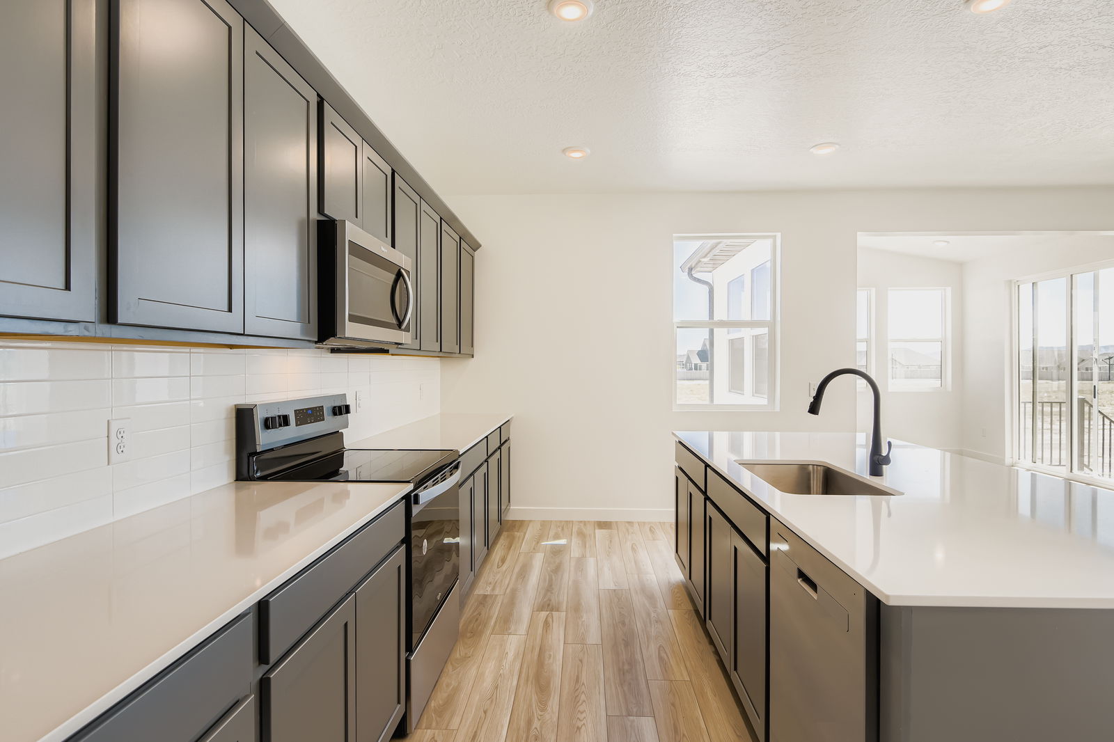 A kitchen with black cabinets.