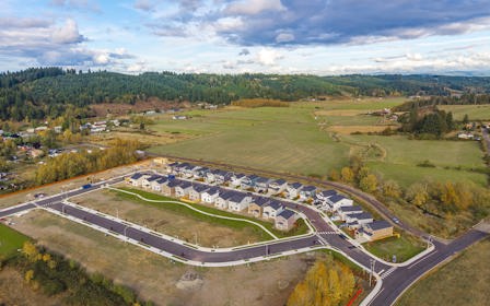 A road with a winding road and trees on the side.