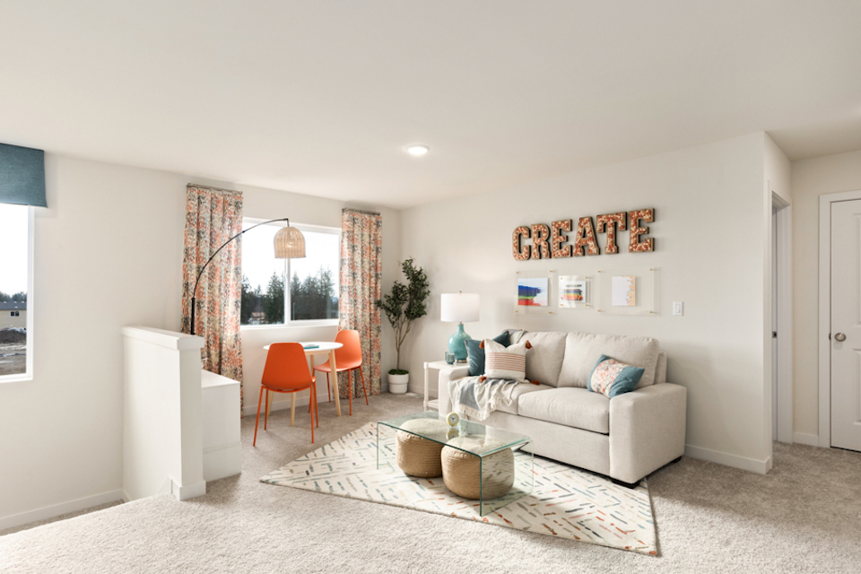 A living room with a couch and a rug.