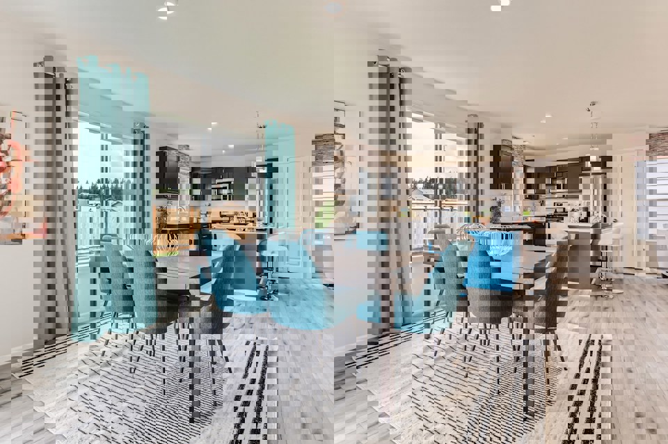 A dining room with a table and chairs.