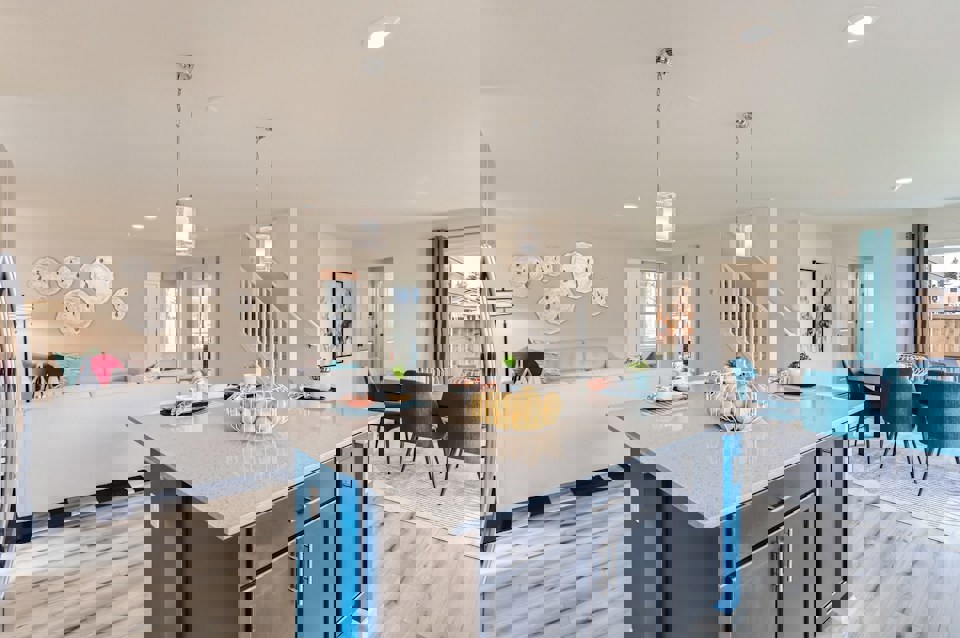 A kitchen with a bar and a dining table.