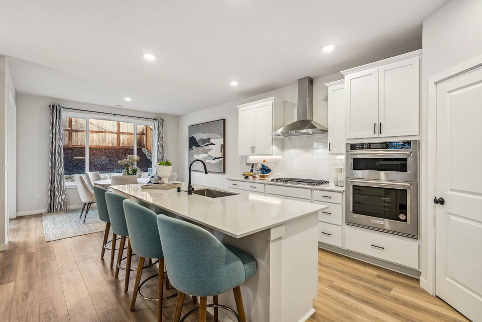 A kitchen with white cabinets.