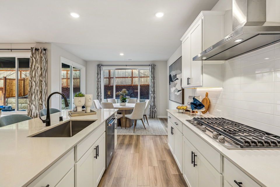 A kitchen with white cabinets.