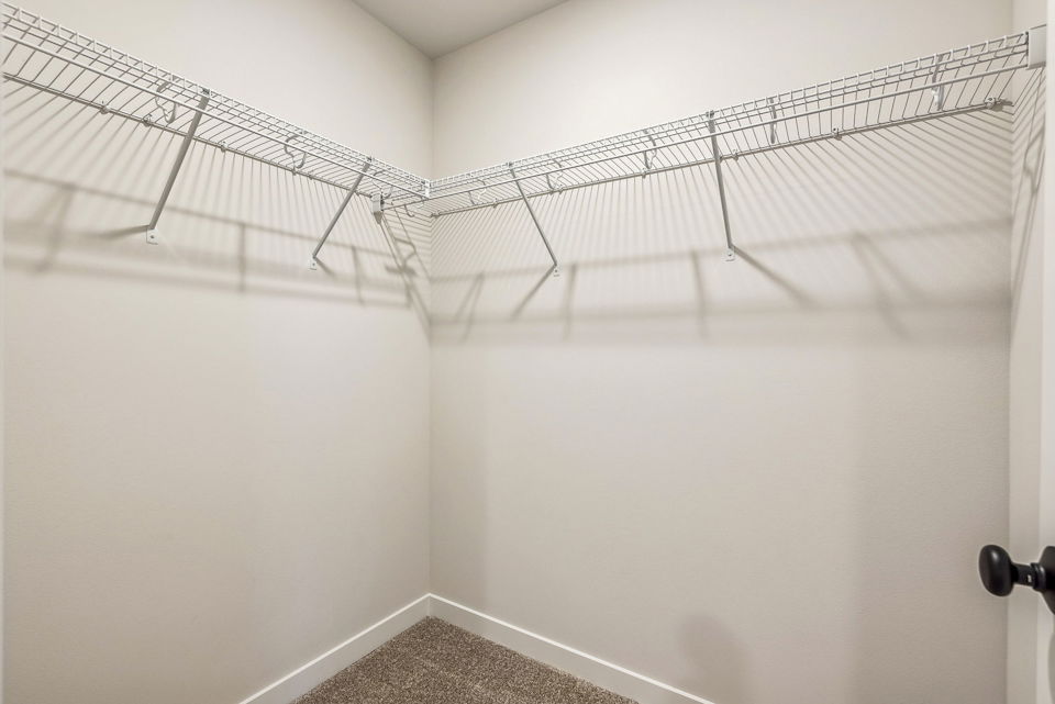 A white wall with a metal railing.