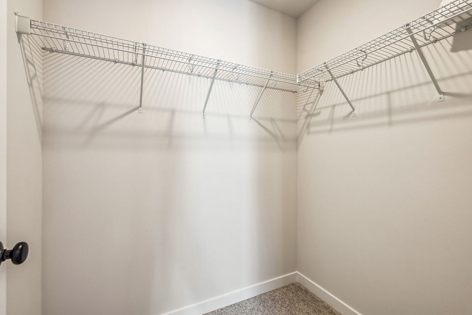 A shower with a metal bar.