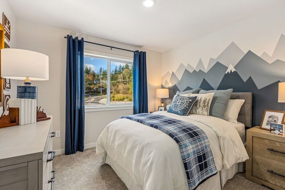 A bedroom with a large window.