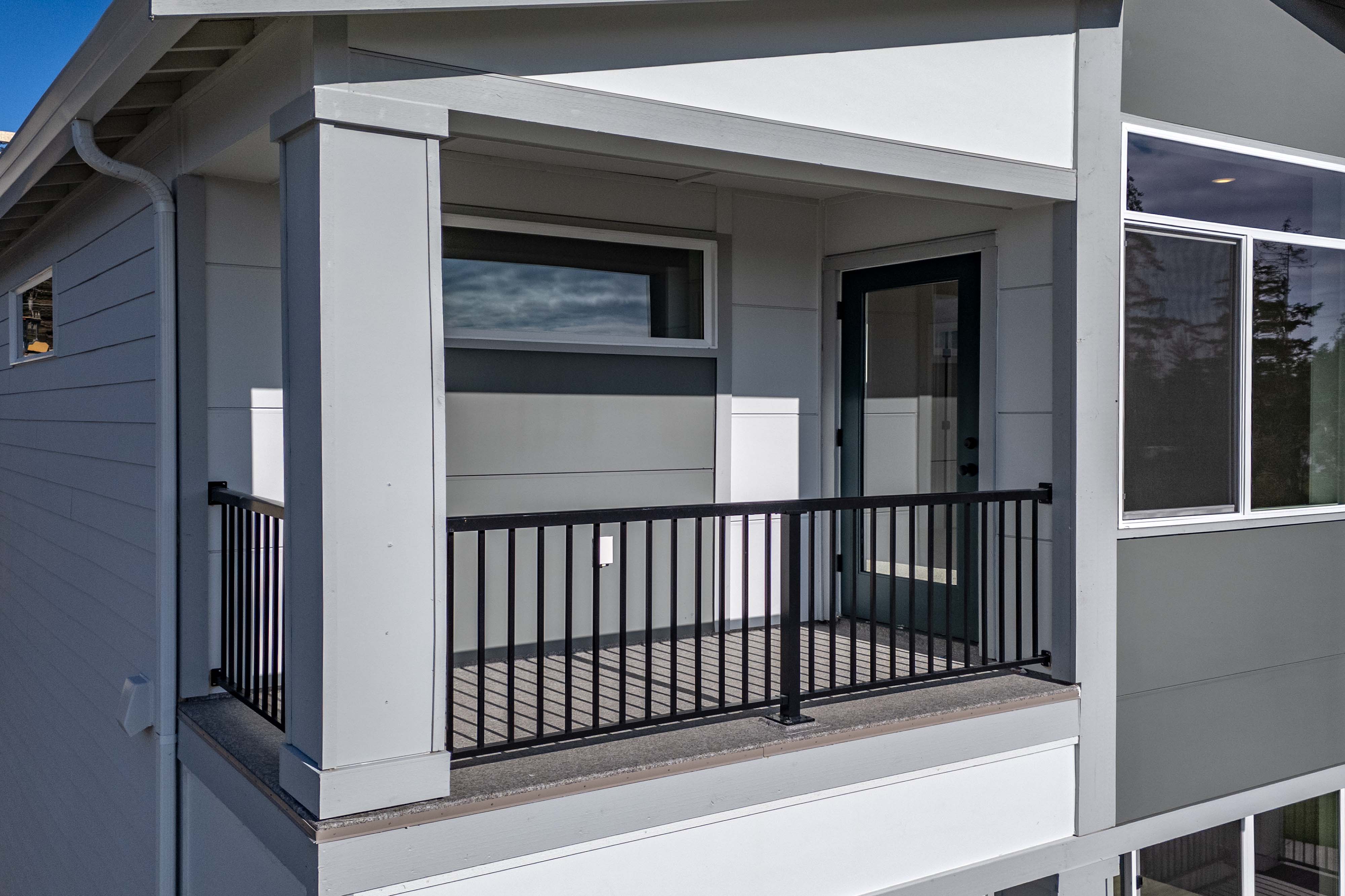 A white house with a black gate.