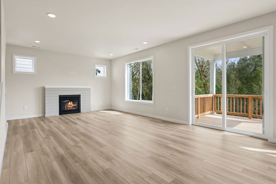 A room with a fireplace and a wood floor.