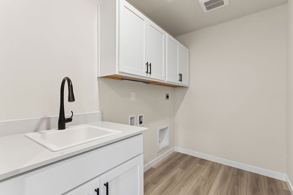 A kitchen with white cabinets.
