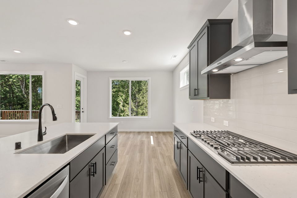 A kitchen with a stove and a sink.