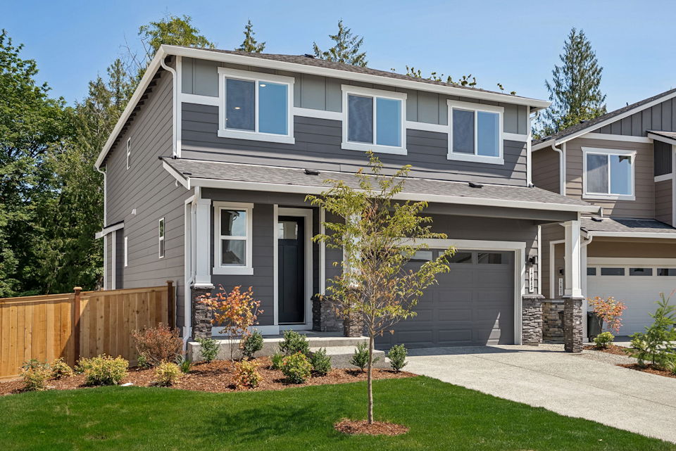 A house with a fence and trees.
